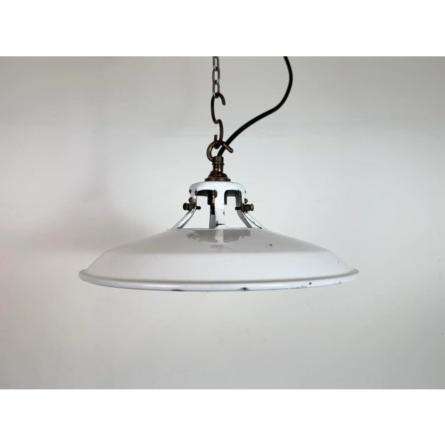 Industrial white enamel factory pendant light made in United Kingdom during the 1960s. White enamel inside the shade....