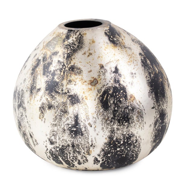 This vase boasts an unconventional round shape that plays with asymmetry, creating an eye-catching and dynamic focal point...