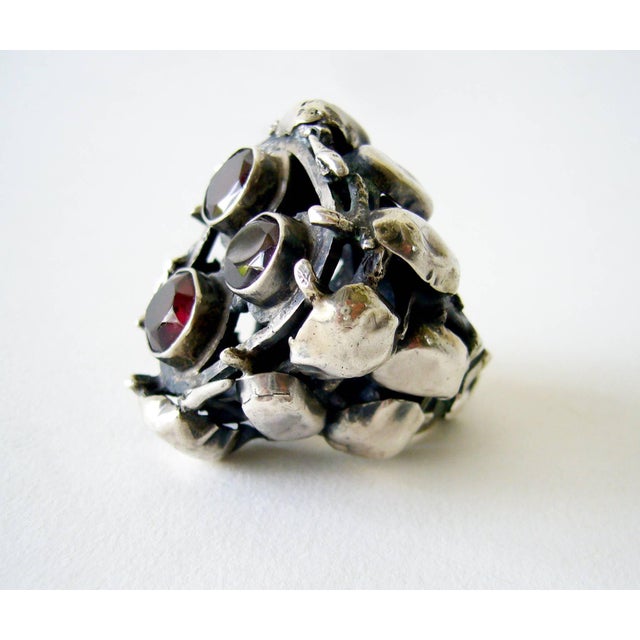 Enormous sterling silver ring with three large bezel set garnets created by Israeli modernist jeweler, Rachel Gera. Ring...