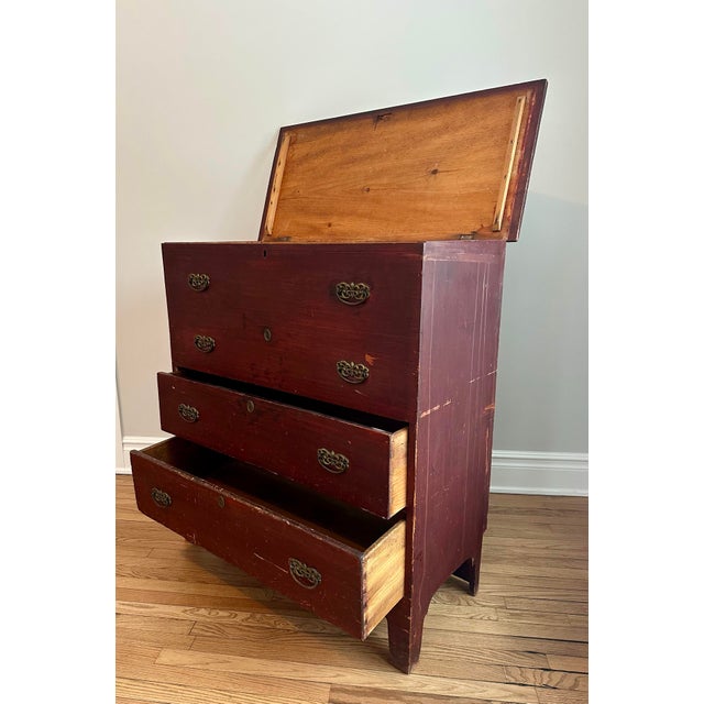 A beautiful early American mule chest in original dark red stained Pine, showing the honest craftsmanship of rural New...