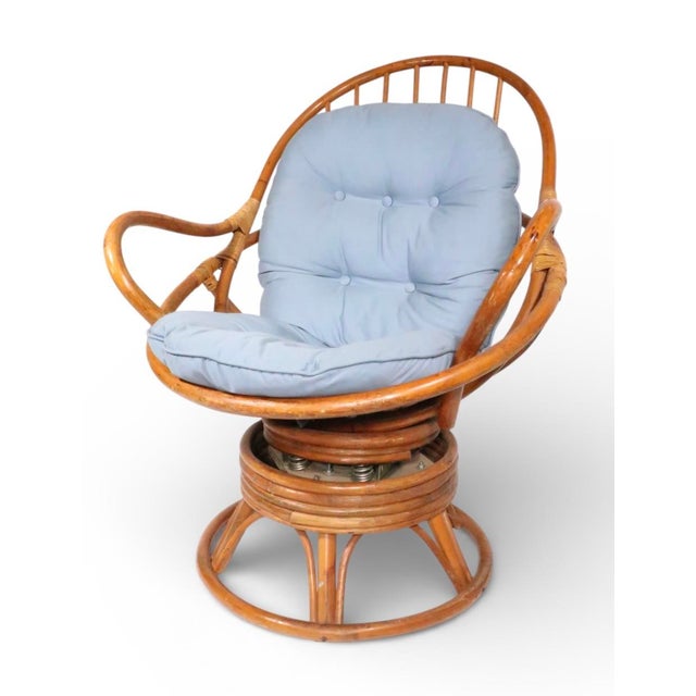 Classic Mid Century bamboo, swivel, tilt lounge chair, and matching footrest, ottoman. The chair, and ottoman are both in...