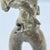 Cast metal maternity figure from Chad, depicting a standing mother holding a child at her side. Figures such as this...