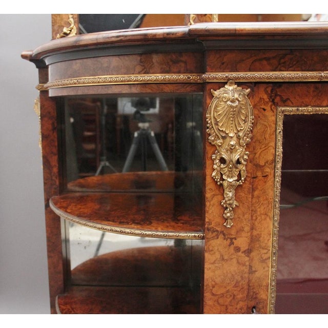 An exhibition quality 19th Century burr walnut mirror back credenza, the shaped mirror back top comprising of a large...