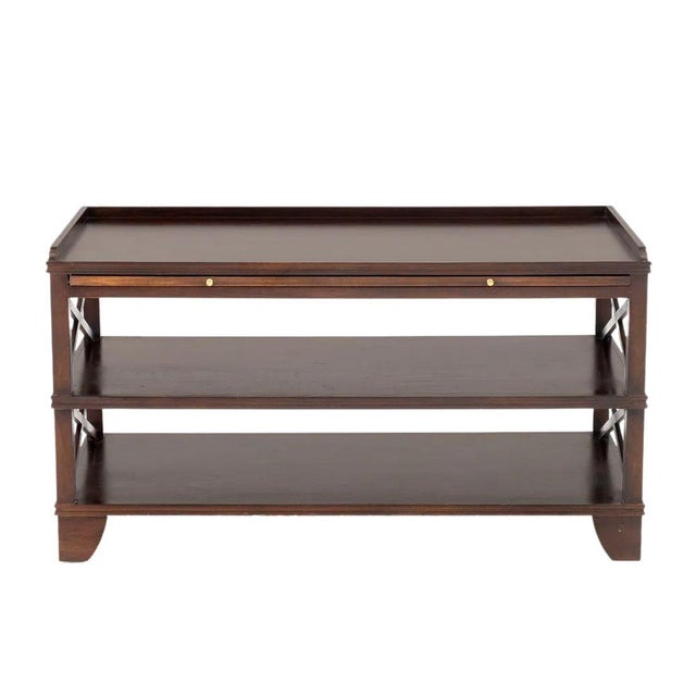 David Iatesta mahogany console table featuring a rich, dark wood finish, three spacious tiers, and distinctive X-form...