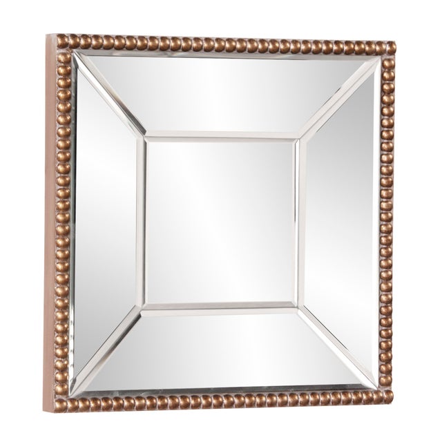 The Lydia Mirror features a square mirrored frame trimmed with an antique gold beaded border. The mirrored frame on this...