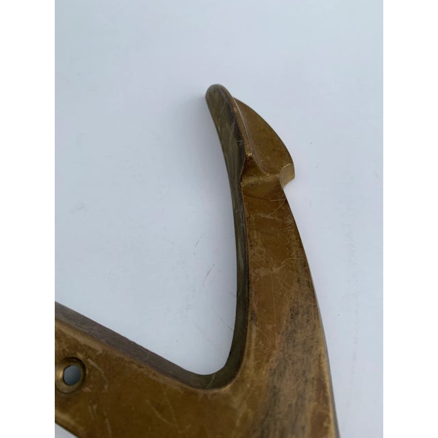 This vintage nautical accent has substantial presence with its heavy brass form and aged patina.