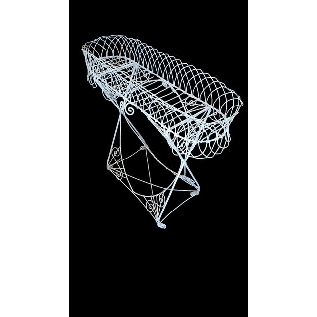 Antique French painted wire plant stand on casters.