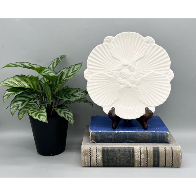 Gorgeous 20th century white ceramic oyster or luncheon plate. Features an overlapping scallop shell design with embossed...