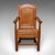 This is an antique schoolmaster's chair. An English, stout oak desk or elbow seat, dating to the Edwardian period, circa...