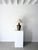 A charming Indian brass lamp with distinct vertical fluted panels tapering toward a narrow circular base. The aged metal...