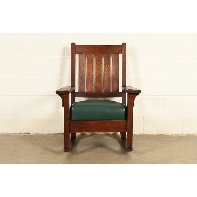 A gorgeous antique Mission or Arts & Crafts period rocking chair By Gustav Stickley USA, Circa 1910 Quarter sawn oak, with...