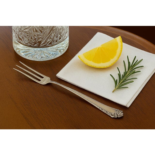 Elevate your barware or tea service with this exquisite Heirloom Sterling lemon fork in the iconic Damask Rose pattern by...