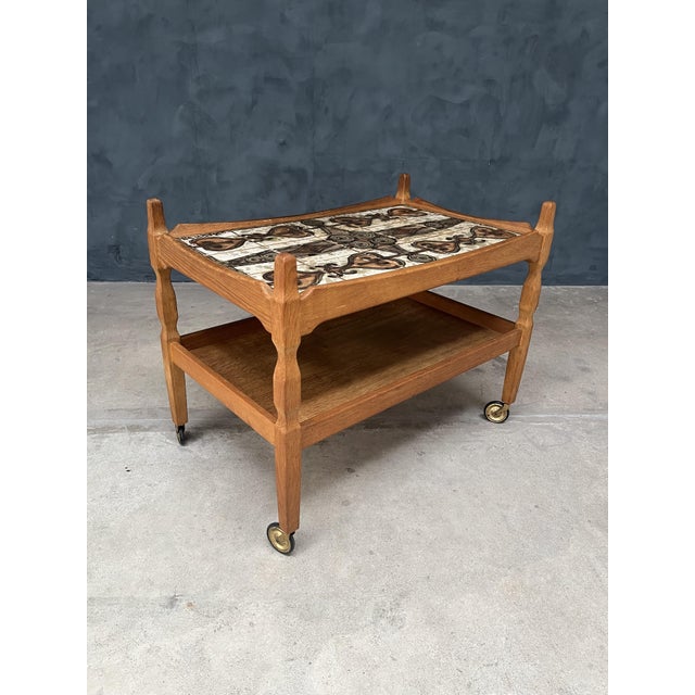 Henning Kjærnulf (Denmark) Midcentury tile inlay rolling table, featuring hand painted and inlaid tiles by OXART, an oak...