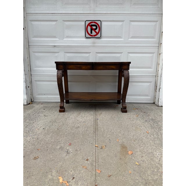 We have a beautiful vintage Empire Revival console table for sale. Featuring magnificent carved scroll legs, intricate...