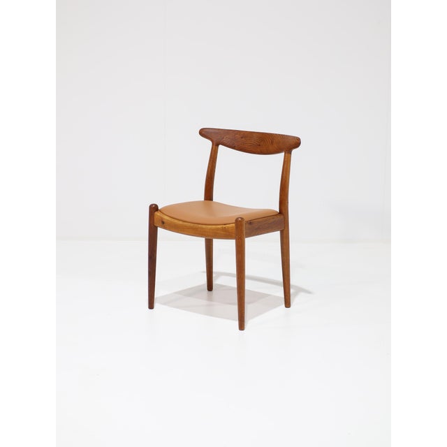 Model w1 chair, designed in the 1950s by hans j. Wegner for c.m. Madsens in denmark. The frame is crafted from oak with a...