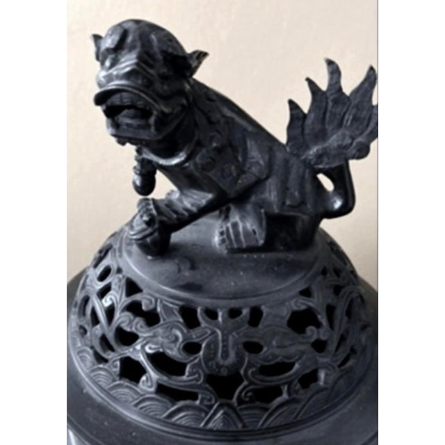 A striking antique Chinese bronze ding-form censer dating to the late Qing Dynastyg (circa 1880–1912). This substantial...