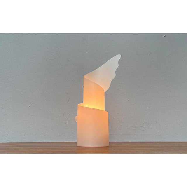 Postmodern table lamp from Slamp after a design by Riccardo Raco from the early 90s. The luminaire body serves as a...
