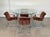 1970s dining set by Guido Faleschini consisting of a round table in chromed steel and glass top (119 cm. diameter X 76 cm....