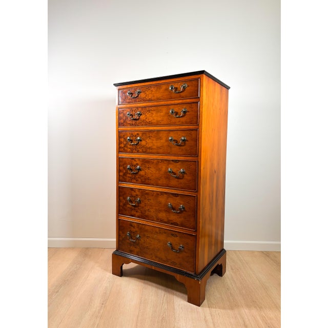 This vintage Louis XV Style tall dresser has six burl wood drawers with original brass hardware and black lacquered...