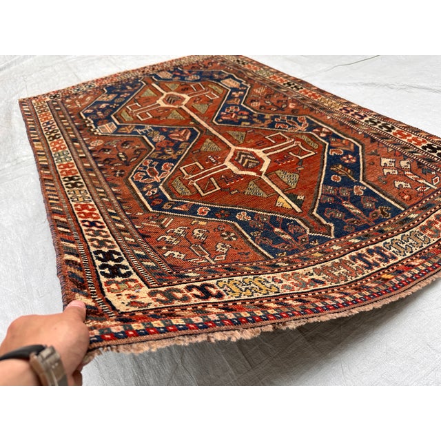 A genuine antique Kashkuli-Qashqai tribal rug from the Fars Province — two bold stepped diamond medallions with cross-...