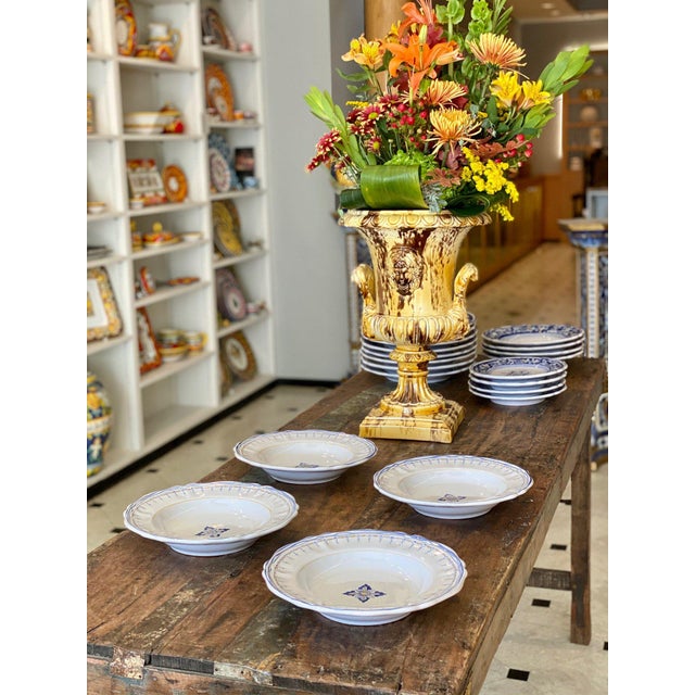 This simplified Antico Deruta dinnerware is characterized by a light gray glaze and a hint of deep blue detail. It is easy...