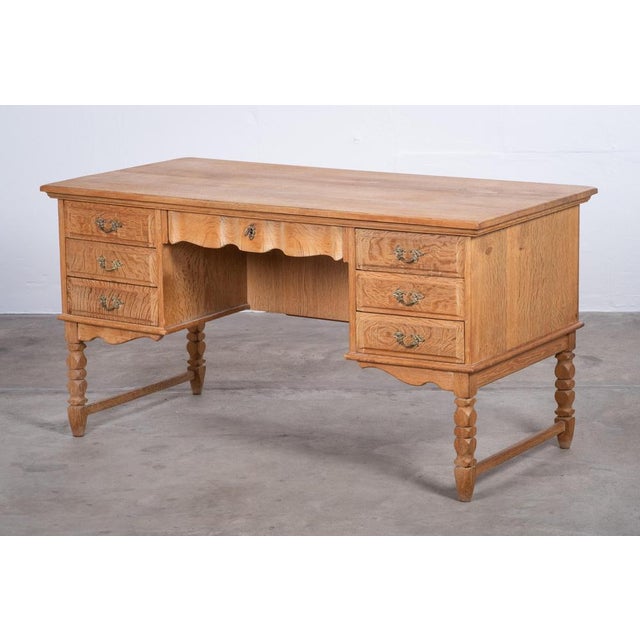 Freestanding desk attributed to Henning Kjærnulf, crafted in solid and veneered Nordic oak in Denmark during the 1960s. A...