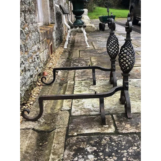 A large pair of 19th century handwrought iron gothic fireplace andirons firedogs. This pair are completely wrought by hand...