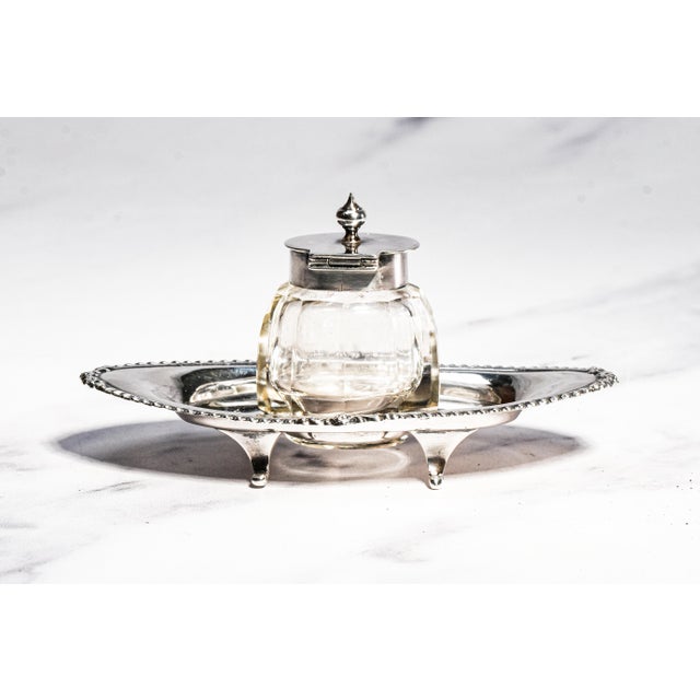 A charming and elegant example of Edwardian desk accessories, this fine English sterling silver and crystal inkwell was...