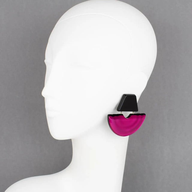 Harriet Bauknight for Kaso designed these sculptural Lucite clip-on earrings. The geometric dangling shape features a...