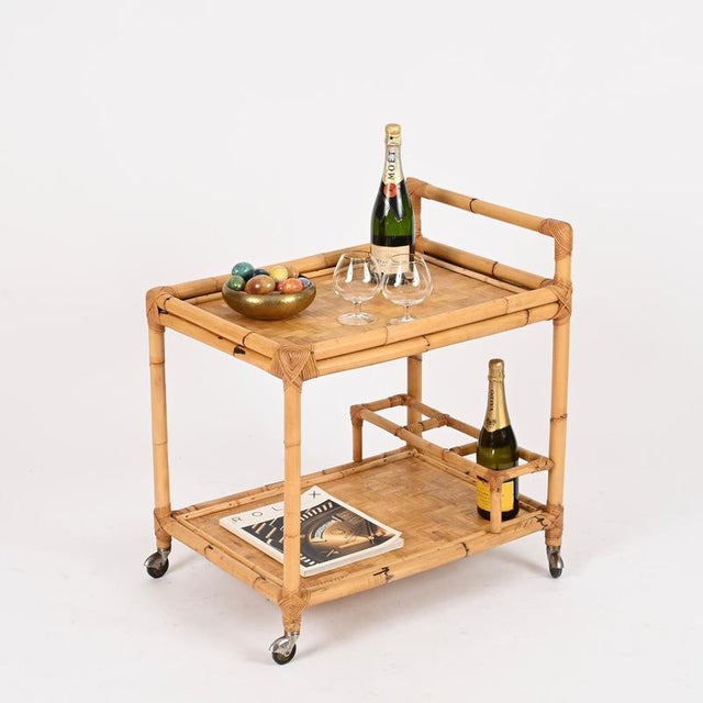 Magnificent Mid-Century rectangular serving bar cart entirely made of bamboo, rattan, and hand-woven wicker. This lovely...