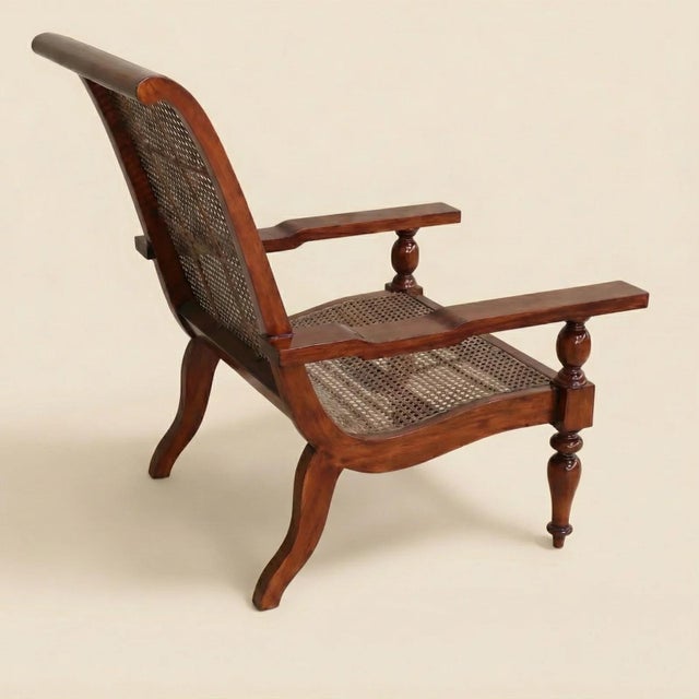 The Hastings Cane Armchair is built in solid kiln-dried mahogany with a plantation-style profile: wide, flat armrests, a...