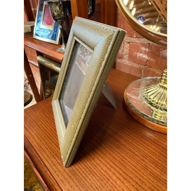 A vintage Italian picture frame wrapped in supple olive green leather with fine contrast stitching and a softly padded...