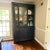 Napoleon Era China Cabinet from Côté Jardin Black antique cabinet with sliding glass doors and two large balck cabinets....