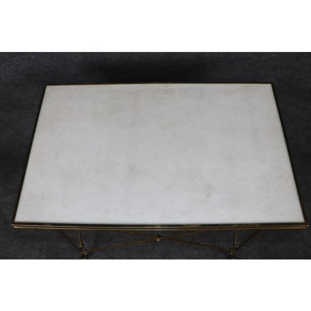 Refined, architectural, and effortlessly sophisticated, this Maison Jansen style Directoire brass and granite-top end...