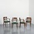 Set of four French armchairs made around 1940. The dark-stained solid oak frame features gently curved armrests and a...