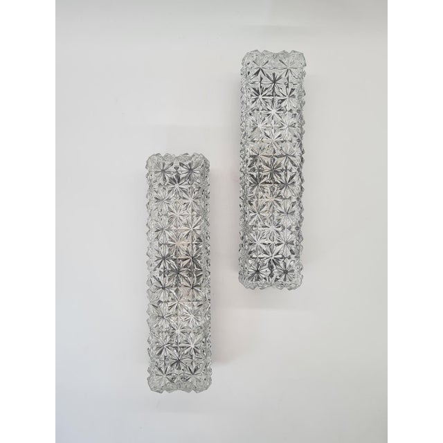 An elegant pair of original german erco leuchten wall sconces, model 4385, dating from the mid-century modern period,...