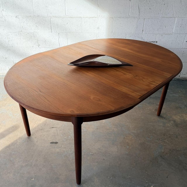 A sculptural carved bowl by American craftsman Emil Milan, made from Bissilon, a rare West African mahogany, and inset...