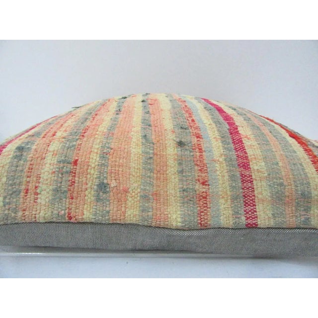 This is a pillow cover made from a vintage kilim rug. The piece was properly washed and ready to use. Pillow inserts not...