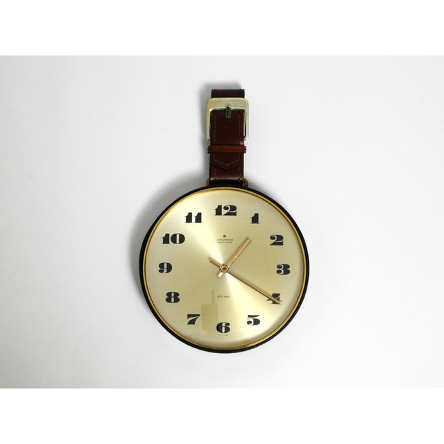 Rare original 1960s Junghans brass wall clock with a genuine leather strap for hanging and glass cover. Made in Germany....
