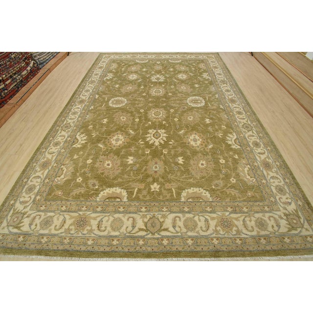 A traditional Ziegler rug hand-knotted with fine wool on a cotton foundation. This rug features a subtle botanical design...