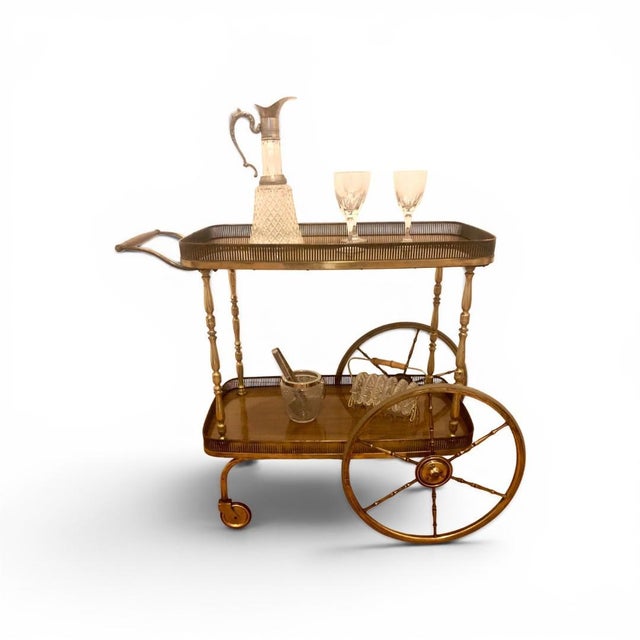 A rare and stylish brass-and-wood serving cart in a mid-century design from the 1950s, designed by Josef Frank for Svenskt...