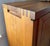 Solid elm cabinet in excellent condition. The front features two asymmetrical doors and drawers, thoughtfully structured...