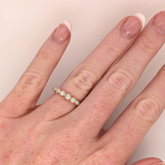 This beautiful bezel set diamond band features 15 natural earth mined diamonds, set in solid 14K gold. This Diamond band...