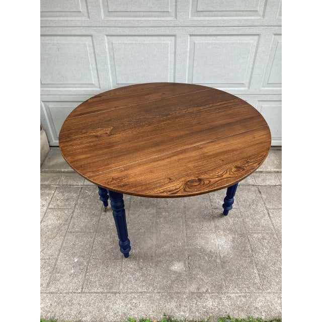 Beautiful Louis XVI-style wooden double-leaf table from the 19th century. Waxed top and base with fluted baluster column...