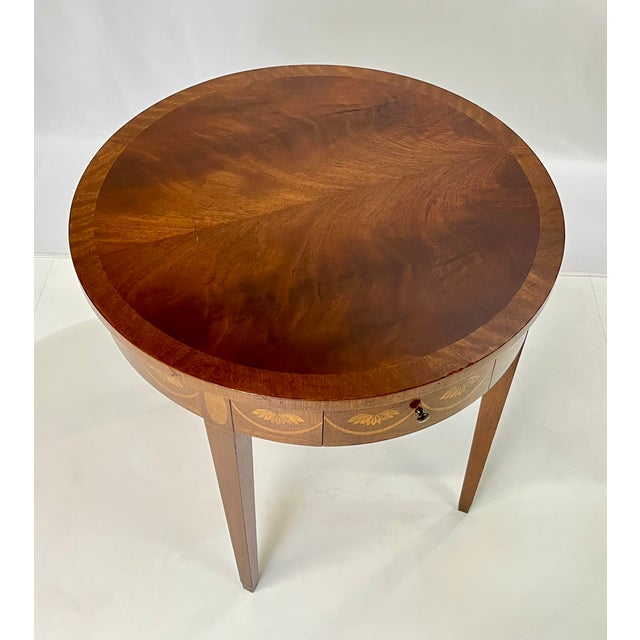 Federal-style drum table by the renowned Baker Furniture. Crafted with an eye for period-correct detail, this table...