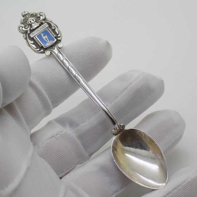 A vintage Austrian silver collector spoon from the 1970s and 1980s, finely crafted and hallmarked 900. The spoon carries...