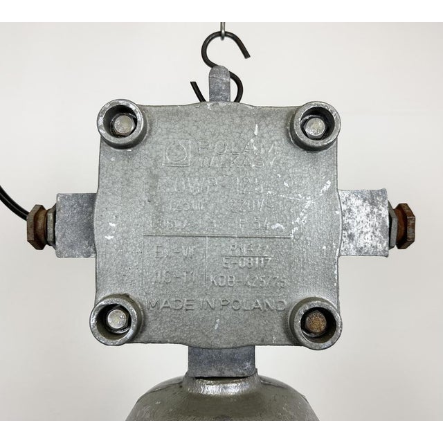 Large industrial factory hanging lamp made by Polam Wilkasy in Poland during the 1960s. It features a cast aluminium body,...