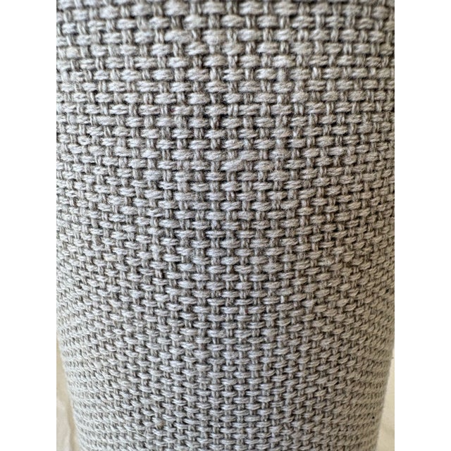 Give your wine presentation a distinctive touch with this cylindrical bottle case featuring textured beige and gray woven...