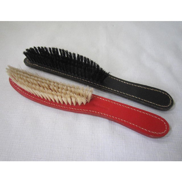 Adorable vintage leather West German Clothes brushes. Red and black leather marked "His & Hers'. Both are in excellent...