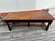 A beautiful and generously sized walnut dining table dating from the early 20th century. It rests on an elegant base...
